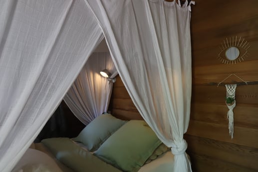 The double bed in treehouse King Louie